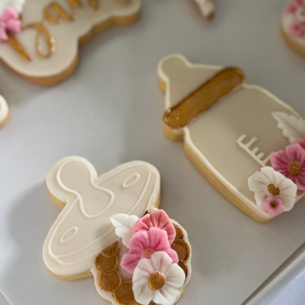 Decorative cookies with floral designs on a white surface