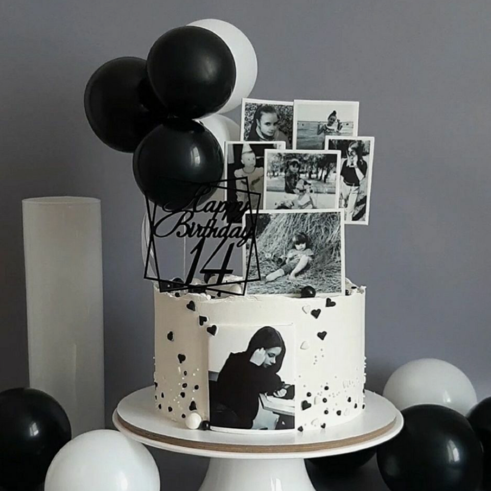 Black and white cake with balloons on a gray background