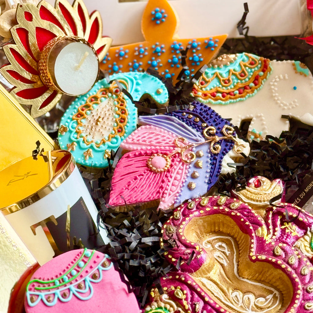 Decorative cookies with intricate designs and colorful icing on a white stand.