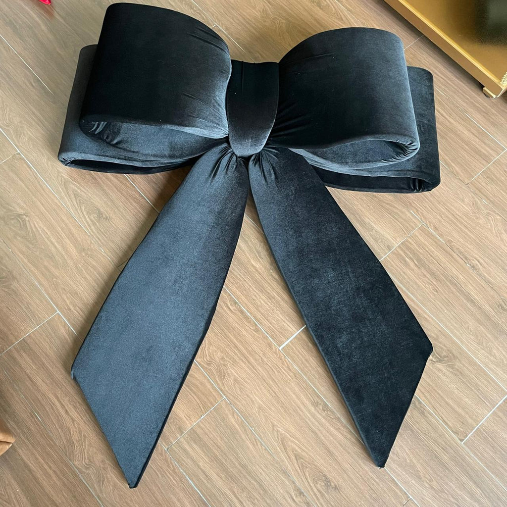 Large black bow on a wooden floor