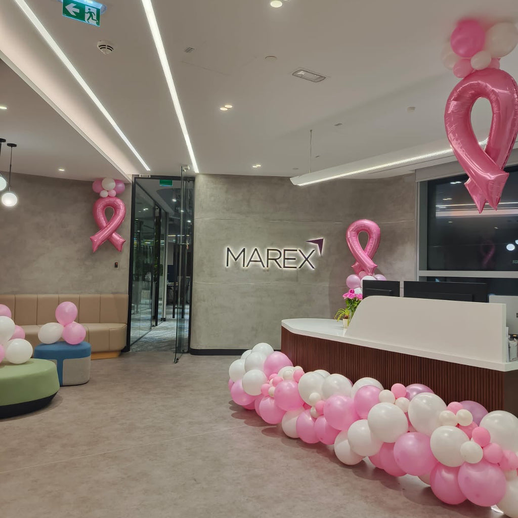 Office lobby with pink and white balloons, MAREX logo on wall