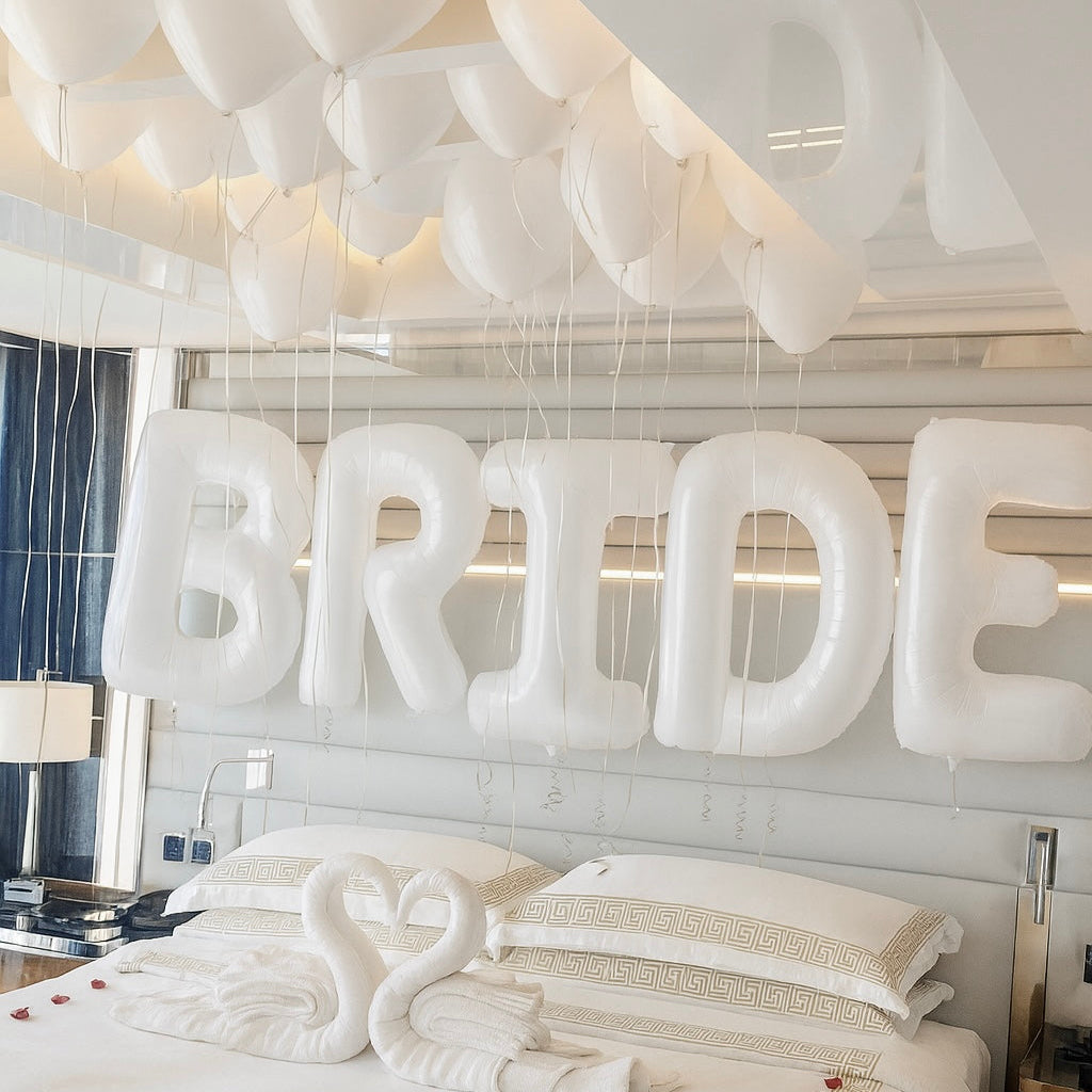 Decorative setup with 'MARRY BRIDE' letters above a bed in a bedroom.