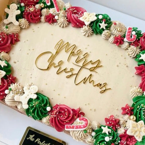 Decorative Christmas wreath with 'Merry Christmas' text and colorful icing on a white background.