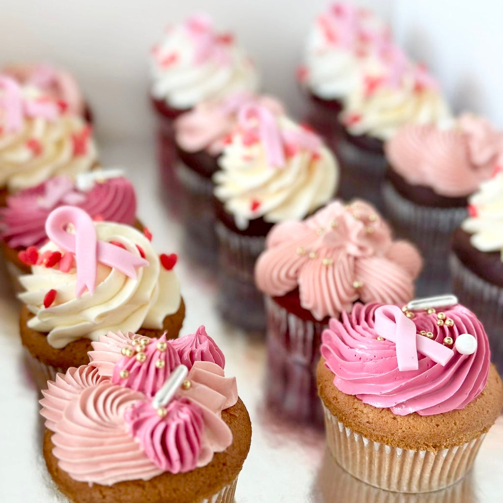 Cupcakes with pink frosting and a visible brand name on a white background