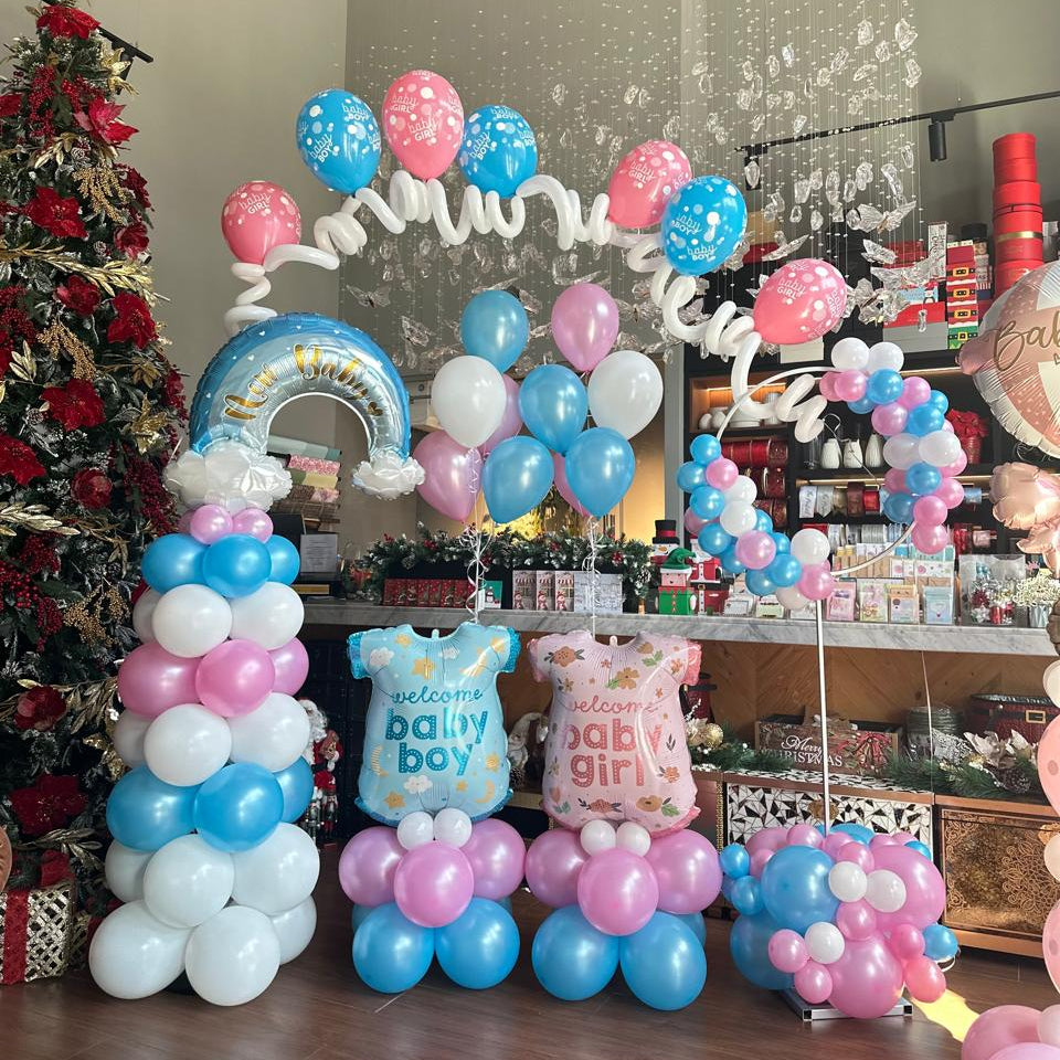 Balloon arch with baby-themed decorations in a store setting