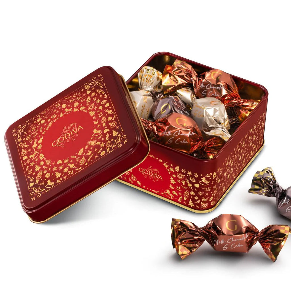Red Godiva chocolate tin with candies on a white background