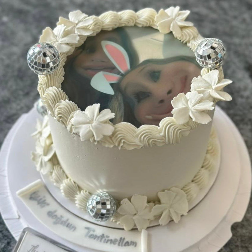 Decorative cake with a decorative top and a small picture 