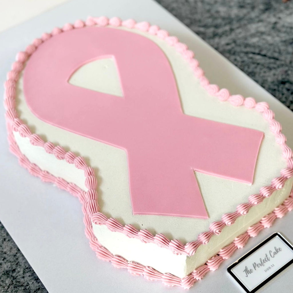 Cake with pink ribbon design on a white background